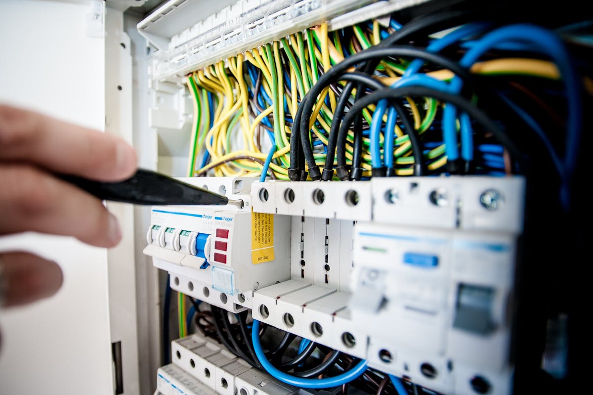 Electrician inspecting a fuse box during an electrical safety check