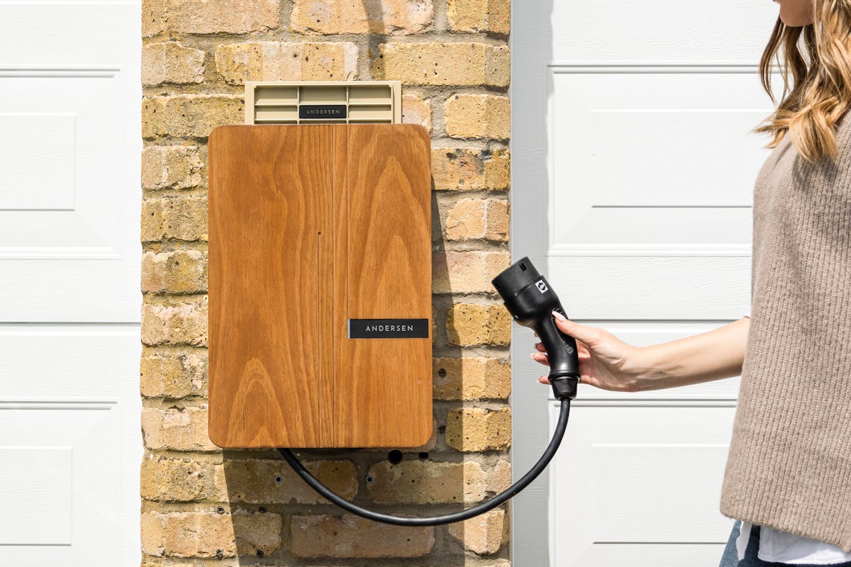 Home EV charger mounted on a house wall