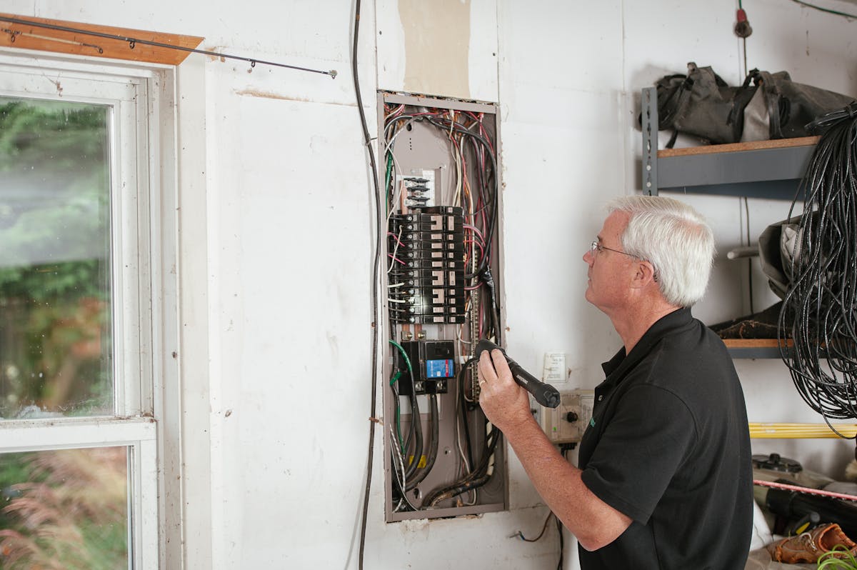 Electrician inspecting a home consumer unit (fuse box)